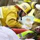 A completely unamused firefighter attends to one of the wreck's numerous injured.